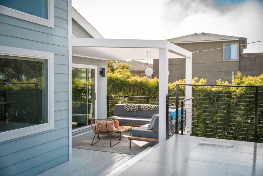 white pergola blue house