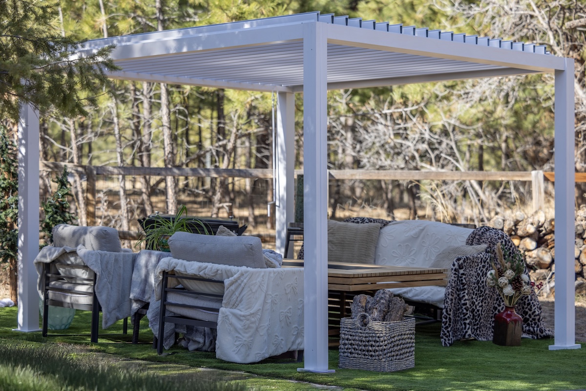 white pergola outside couches