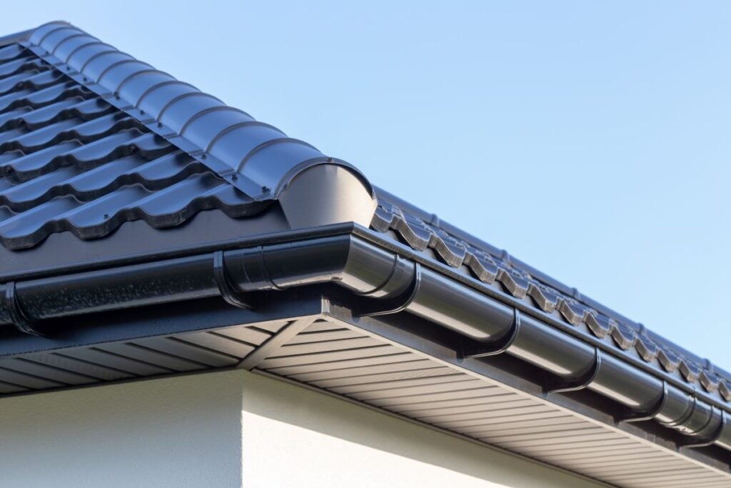corner of a modern house showing half round gutters