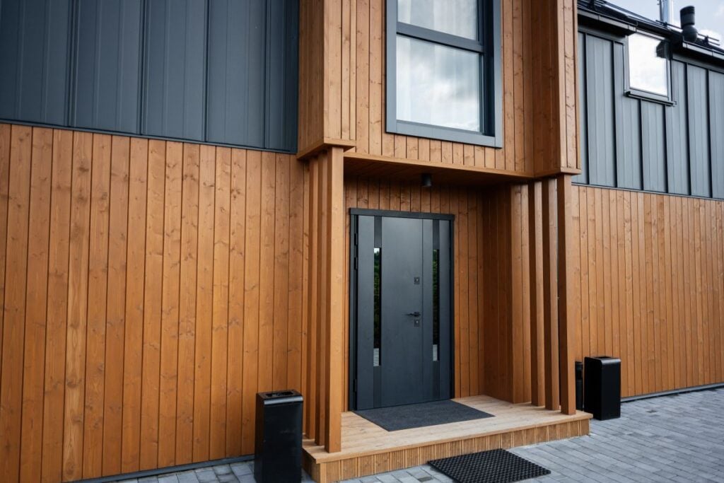 Modern wooden house exterior with stylish entrance and vertical siding design