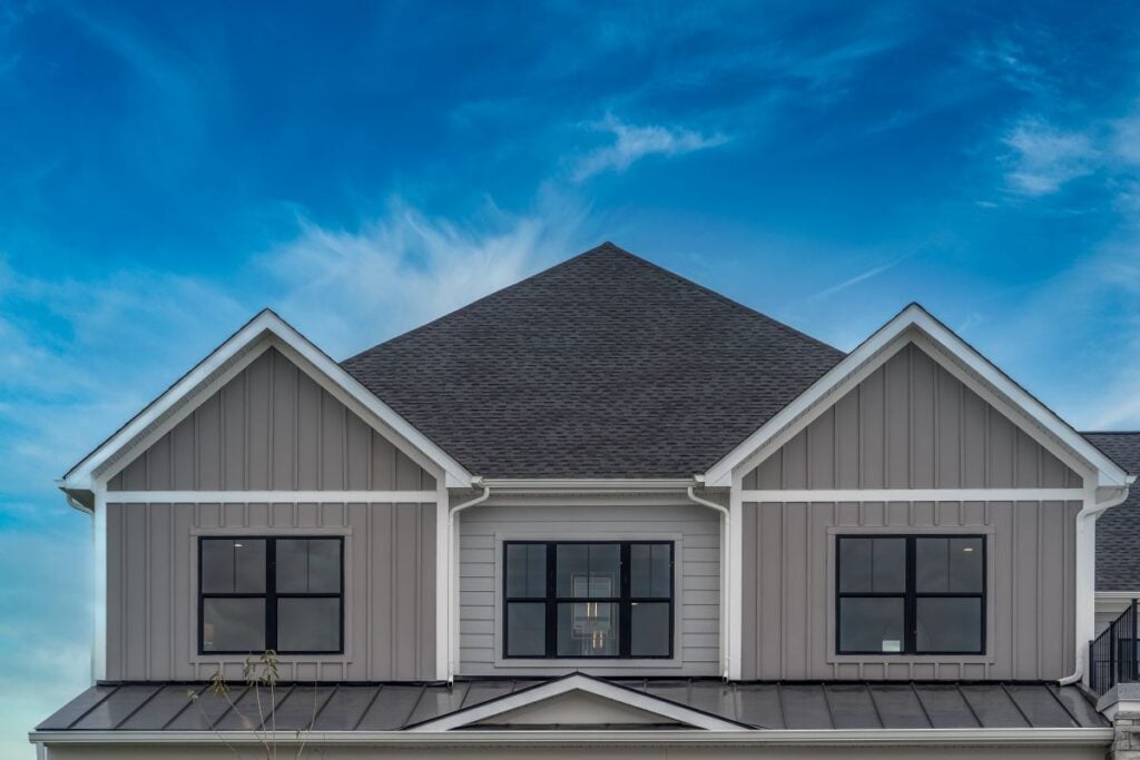 Upscale American house façade with vertical beige vinyl siding
