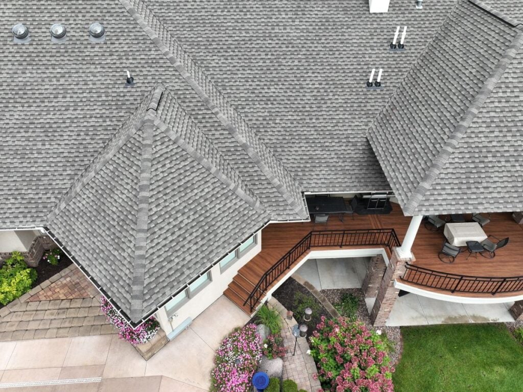 aerial view of a large house with light grey asphalt shingles