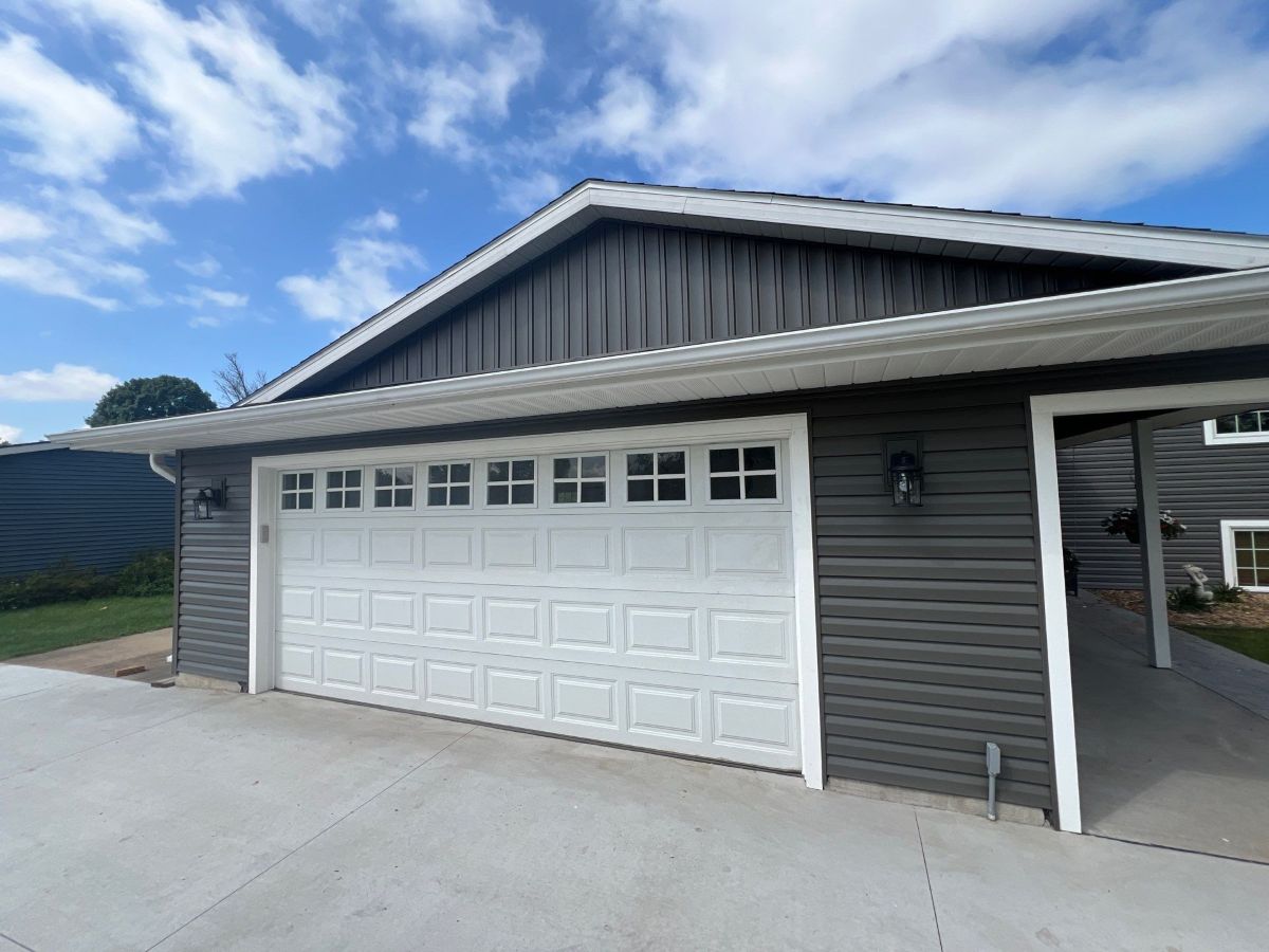 House with siding and a white garage door