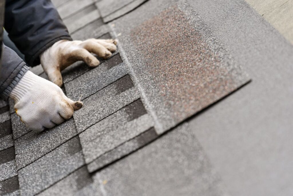 Workman install tile on roof of new house under construction