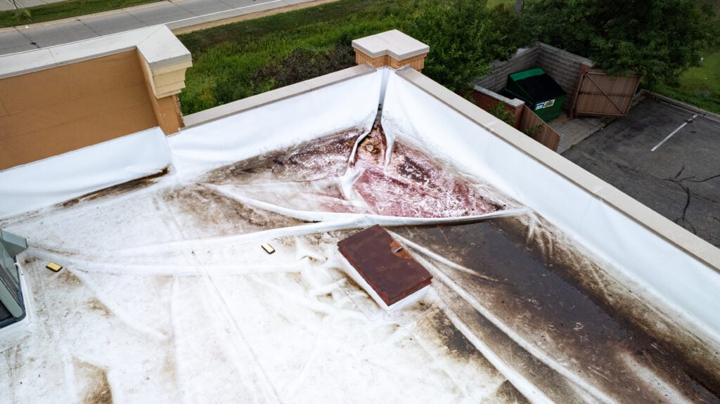 what types of commercial roofing systems are used in winona wi aerial view of damage on top of a TPO roof