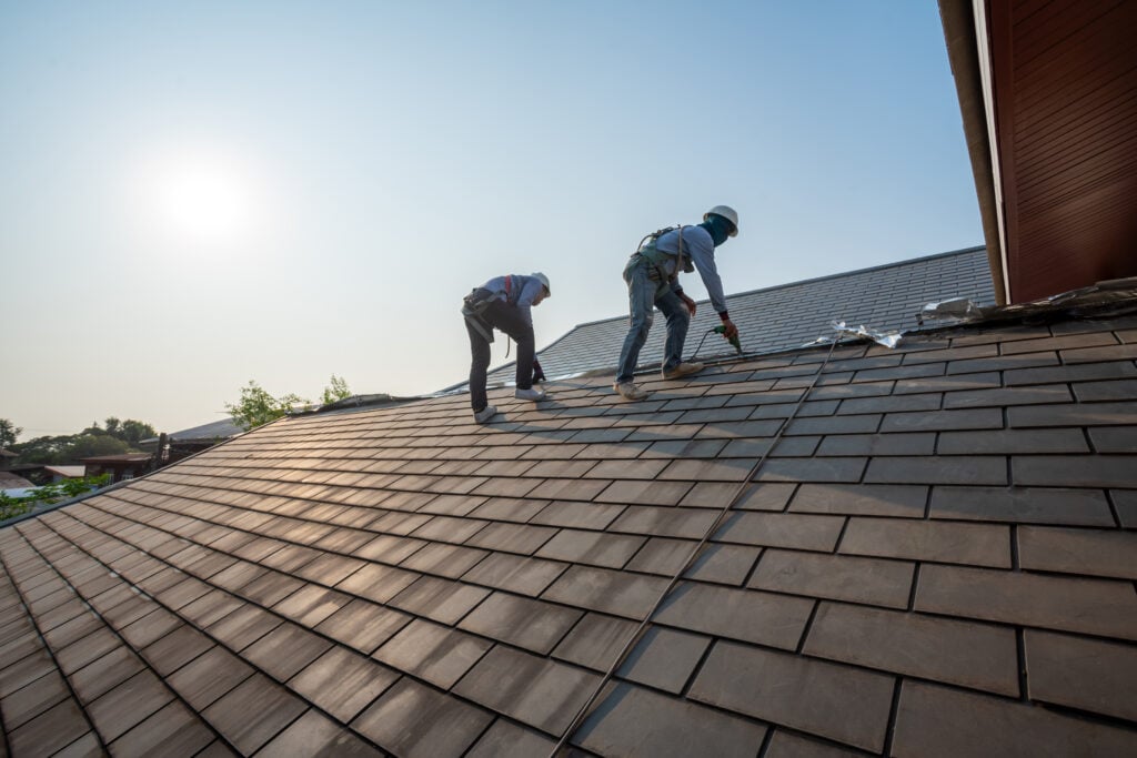 Roofer working in special protective work wear gloves, 