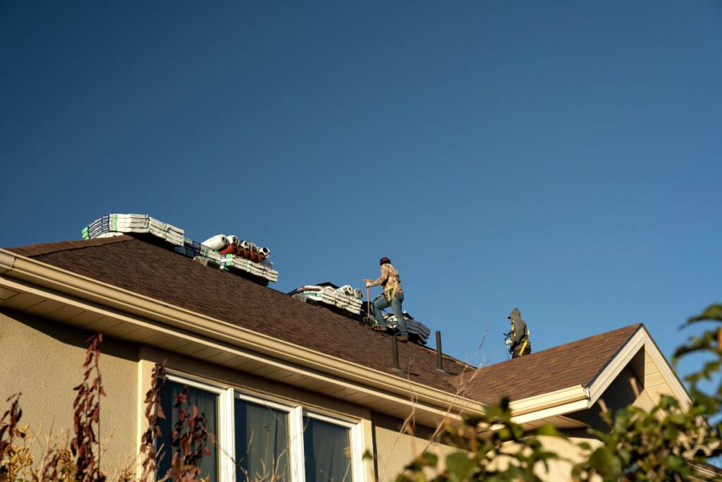 what signs of roof damage are common in la crosse wi homes workers repairing roof after damage