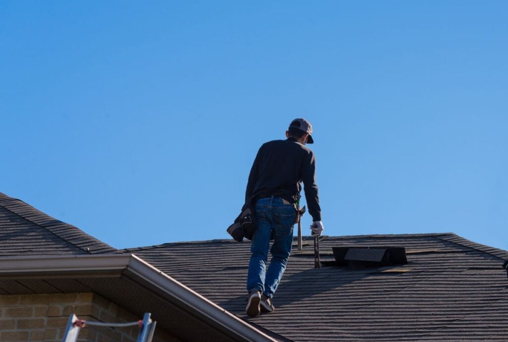 how often should a roof be inspected in sparta wi worker walking on top of shingles roof